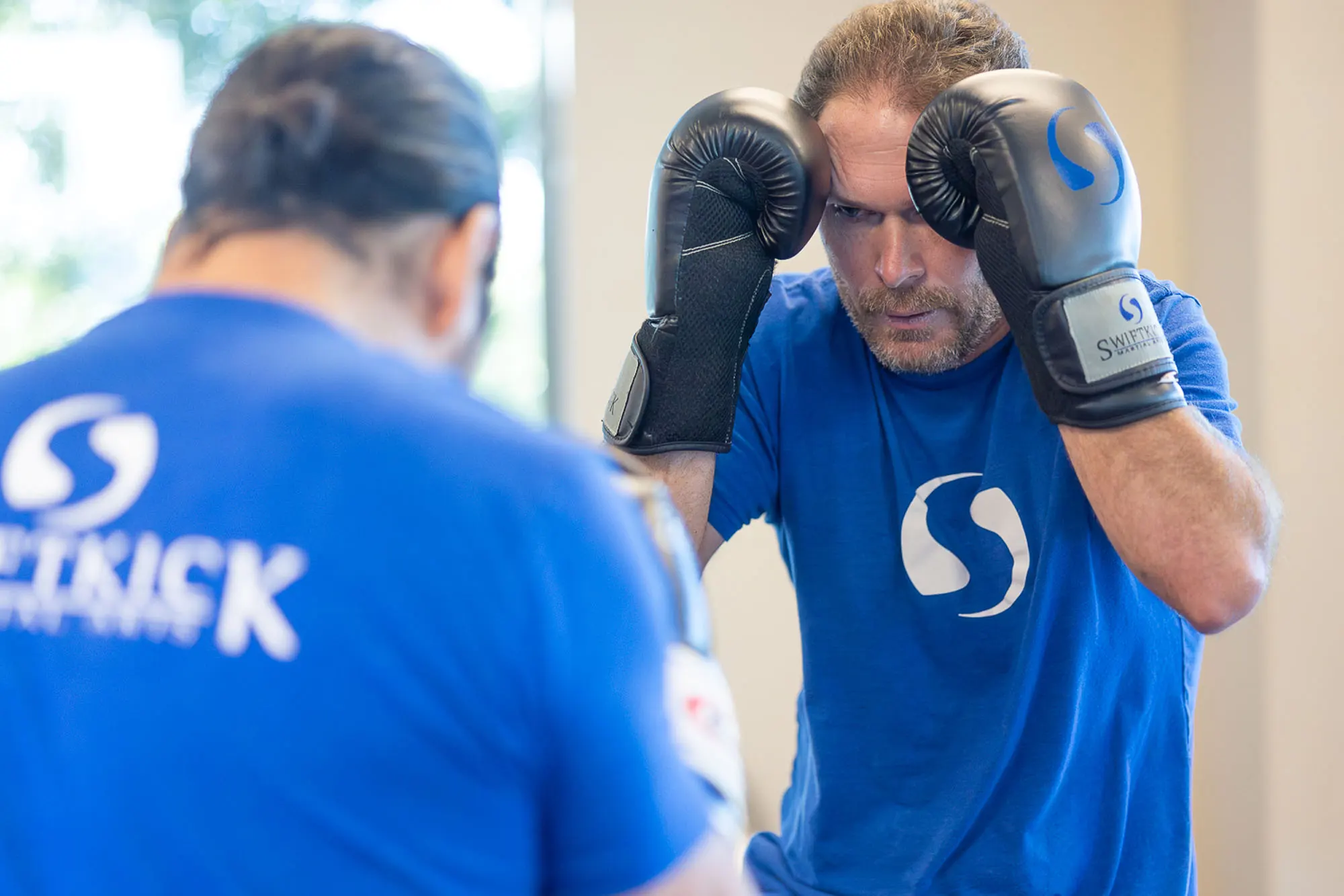 Adult self defense training session with instructor guidance