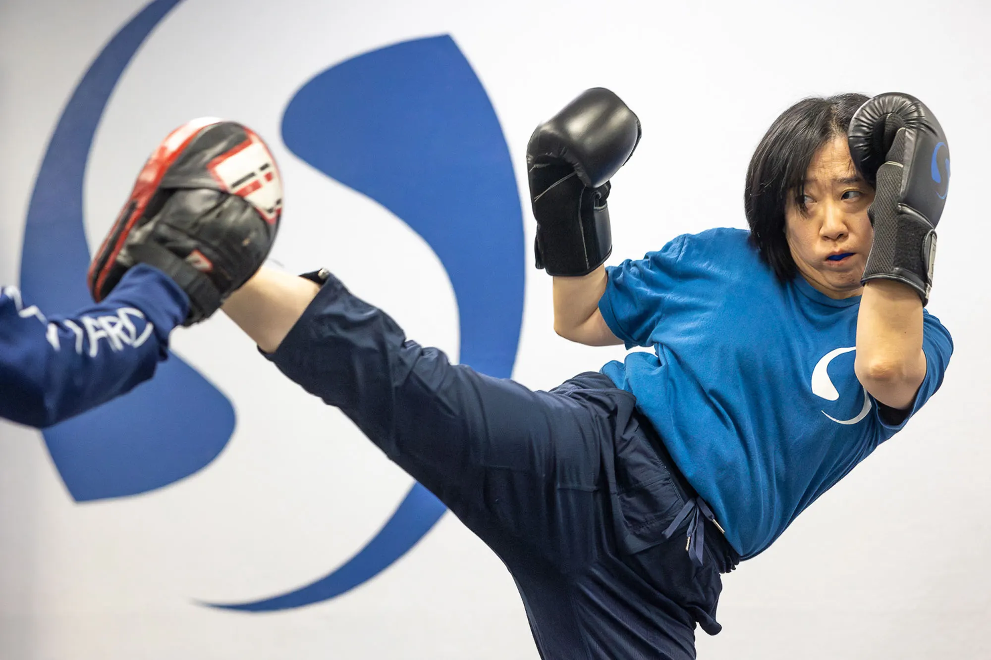 Women's self defense class participants learning defensive techniques