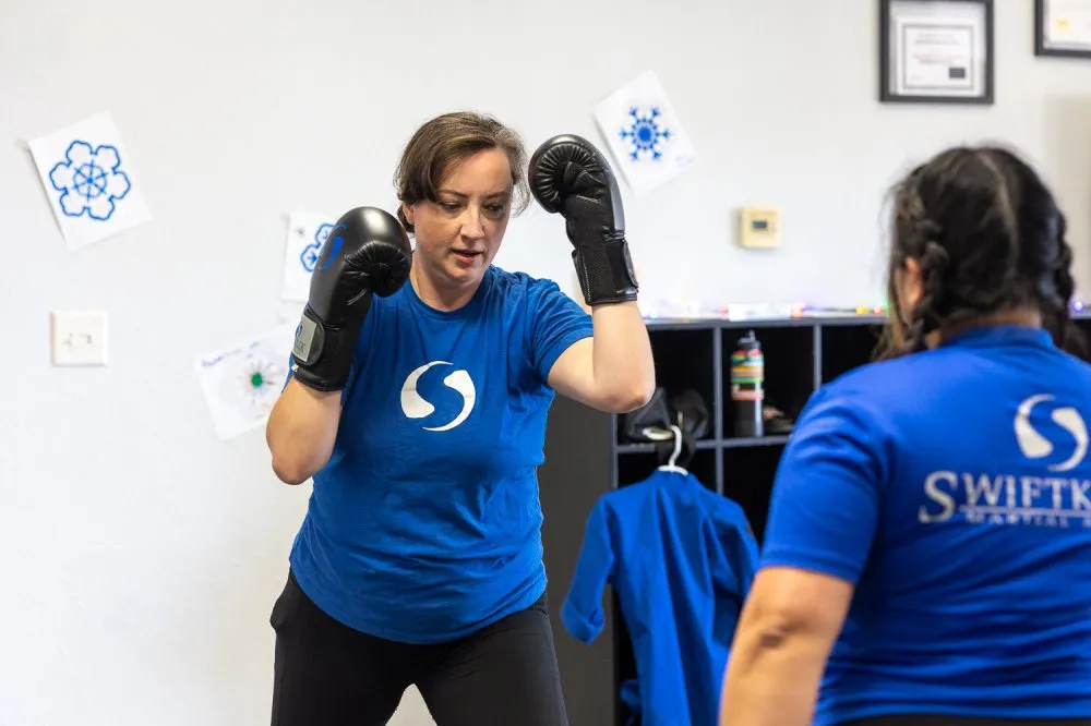 Woman practicing boxing defense at a martial arts class in Rancho Bernardo