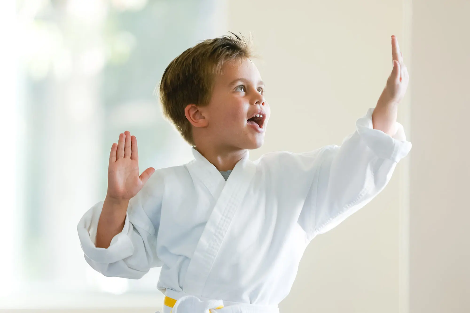 Young child practicing kids martial arts techniques with instructor in San Diego