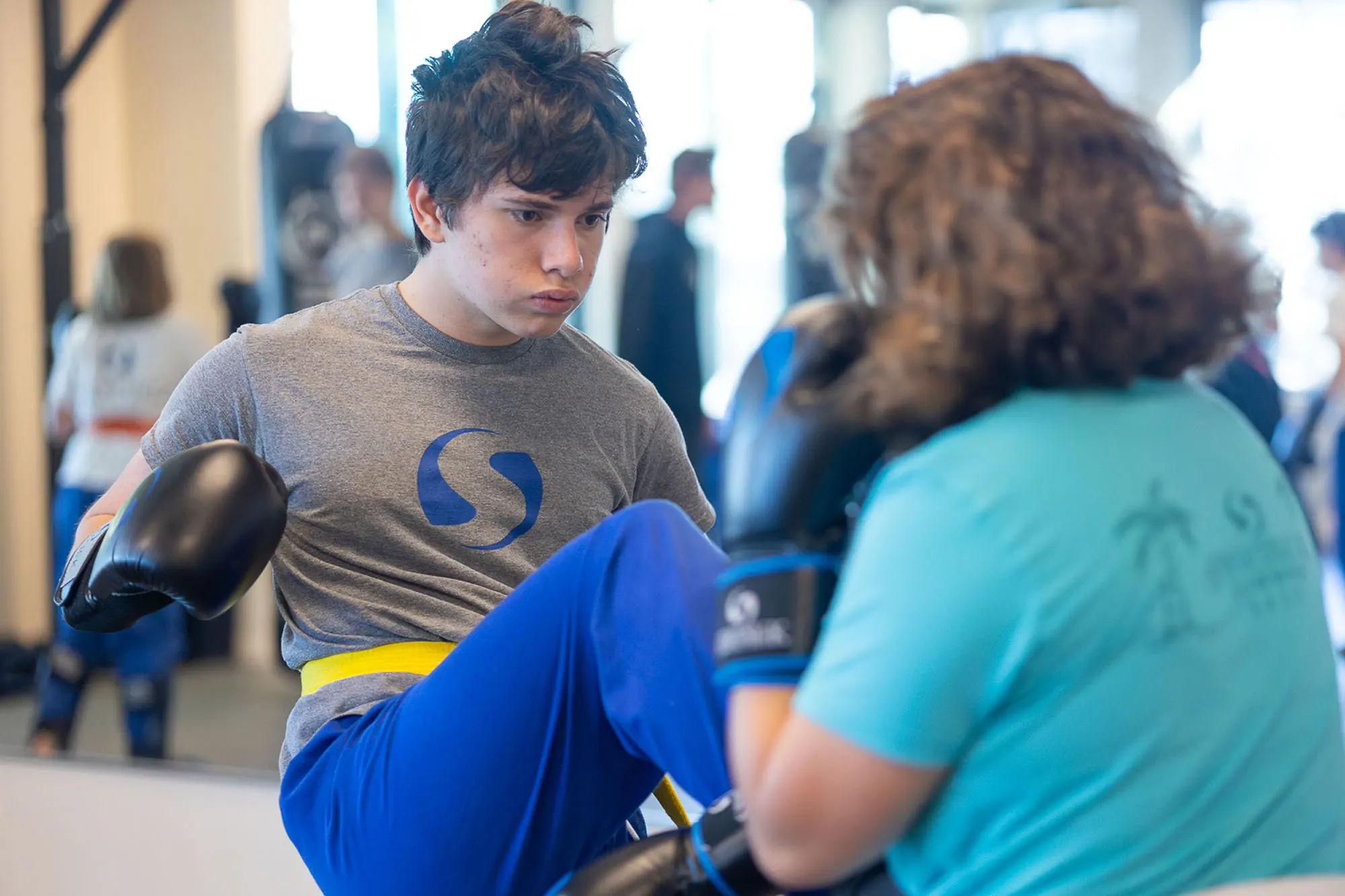Teen martial arts students learning self defense skills during training