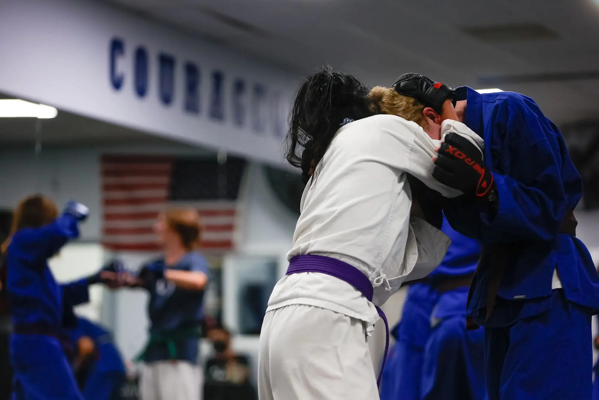 Teen martial arts students practicing self defense moves in Impact program class