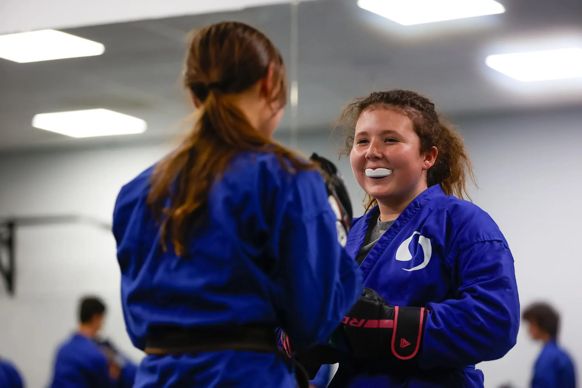 Teen students practicing self defense techniques in martial arts class
