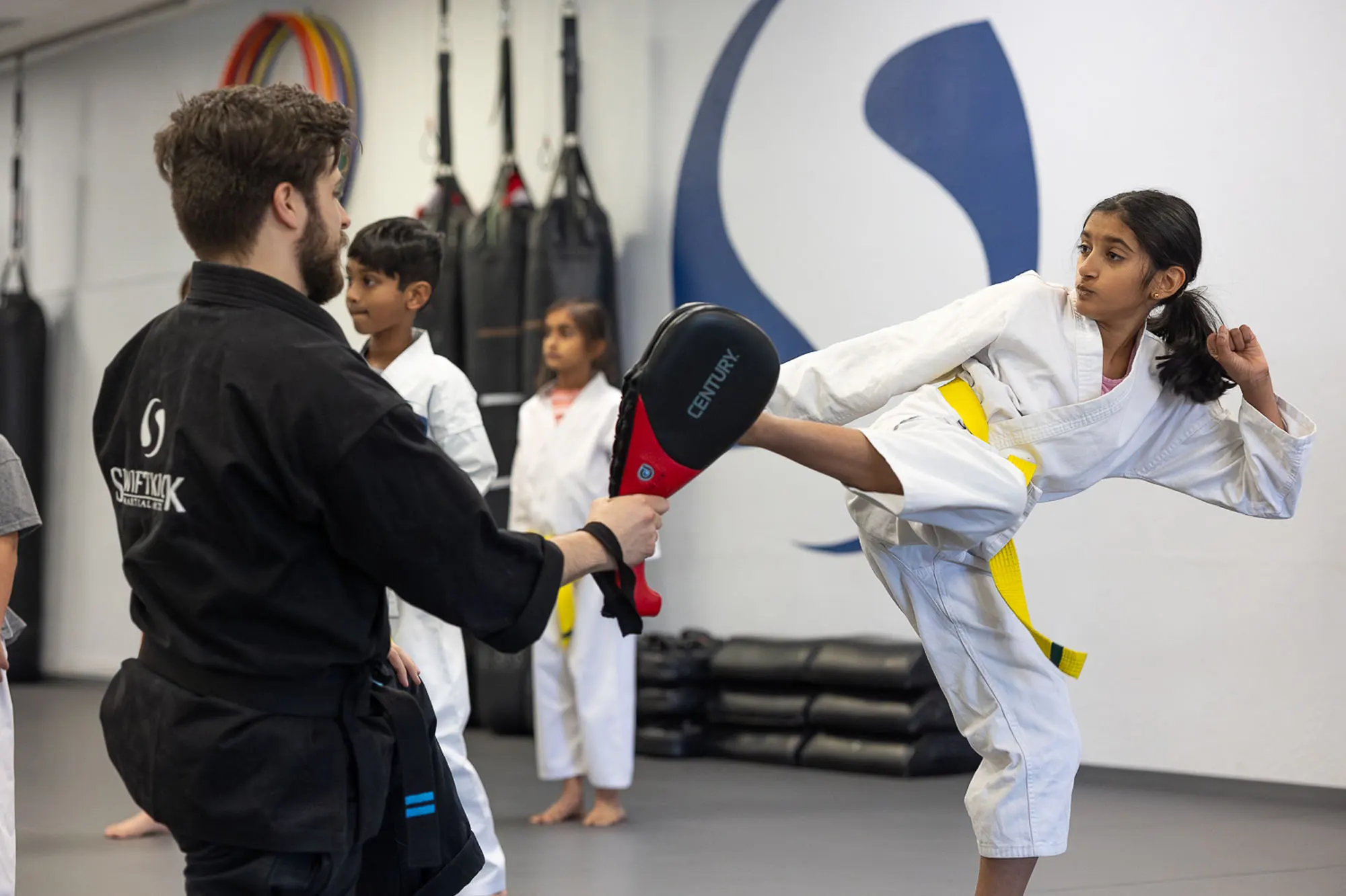 Young students learning self-defense and character development in martial arts for kids program