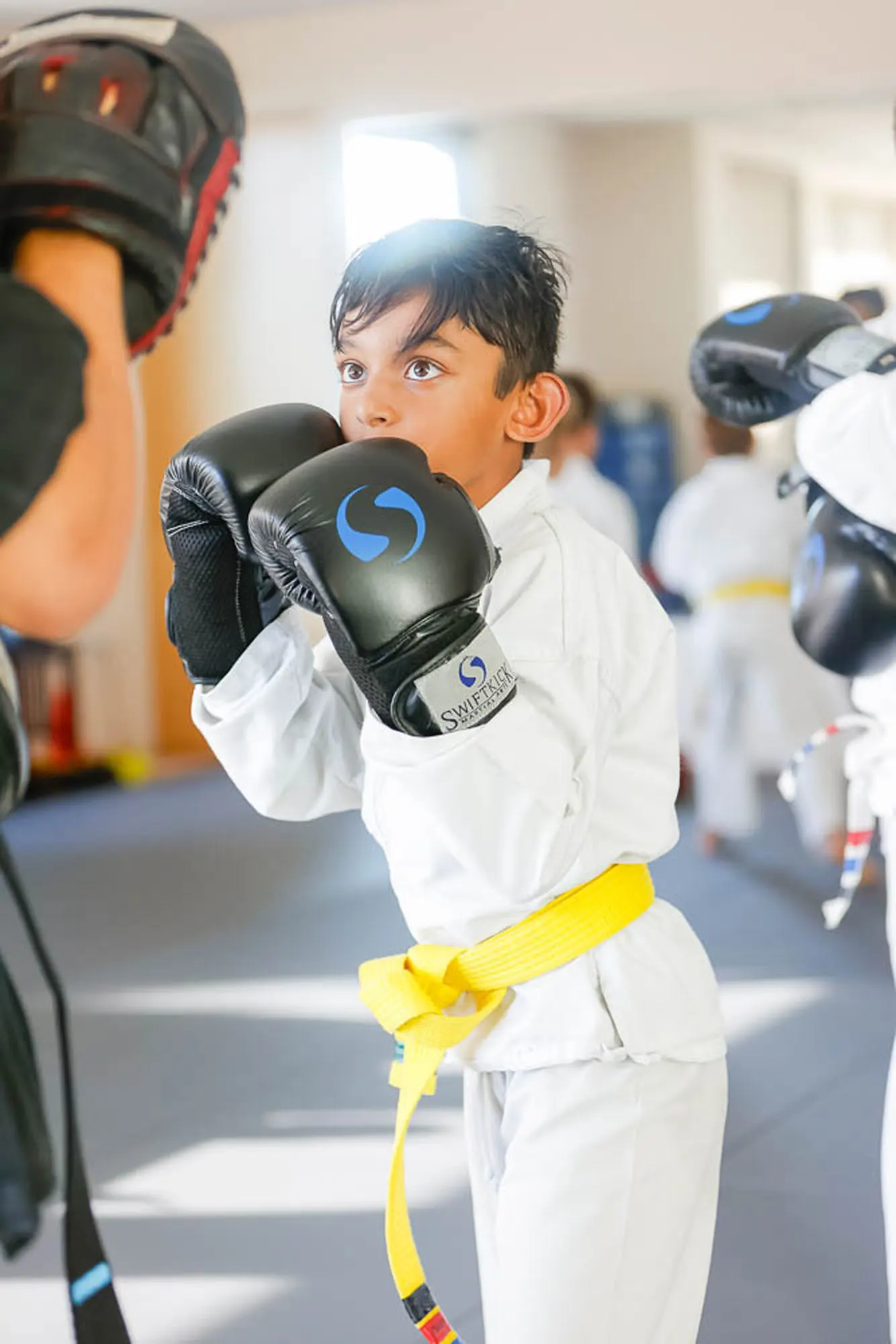 Children ages 5-9 practicing kids martial arts classes in San Diego with certified instructors