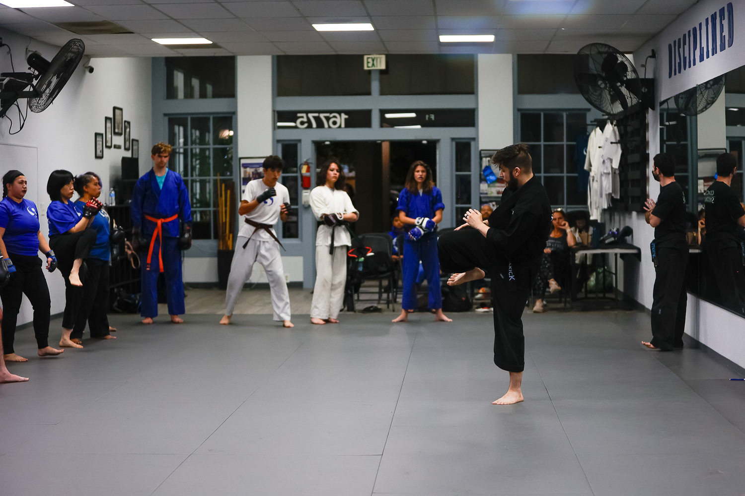 adult group learning kicks in swiftkick martial arts training