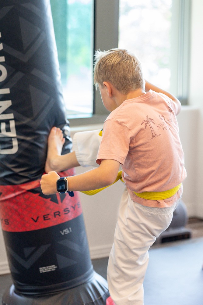 child training in muay thai kicking