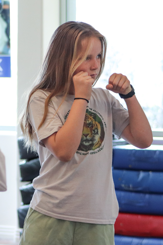 Young girl with her hands up ready to fight