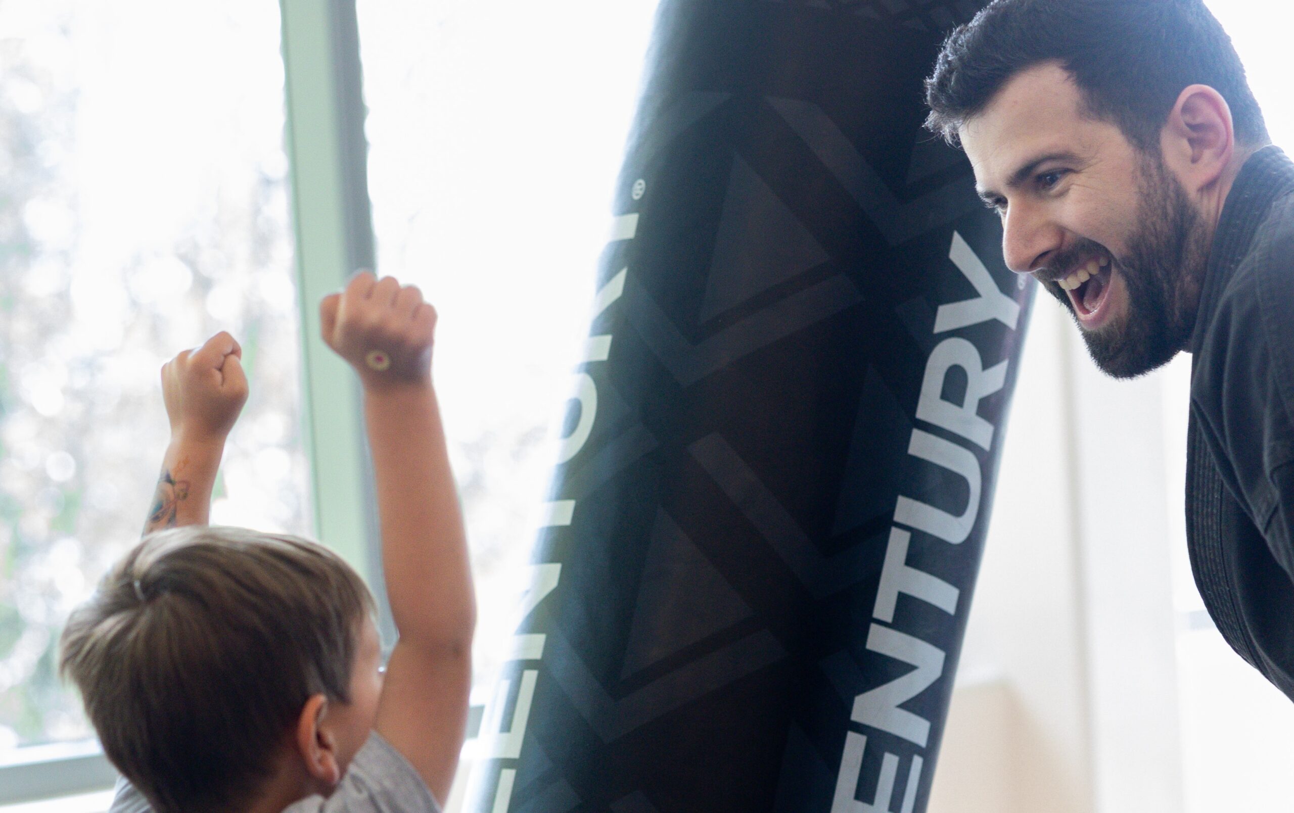 swiftkick-martial-arts-summer-camp-2025 happy boy and instructor sharing his enthusiasm