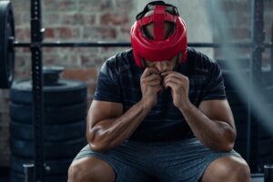 Boxer sitting beside the ring contemplating the effectiveness of martial arts for anxiety and depression.