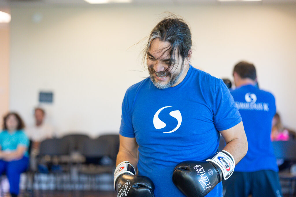Adult champion member smiling, enjoying the martial arts drill he's working on.