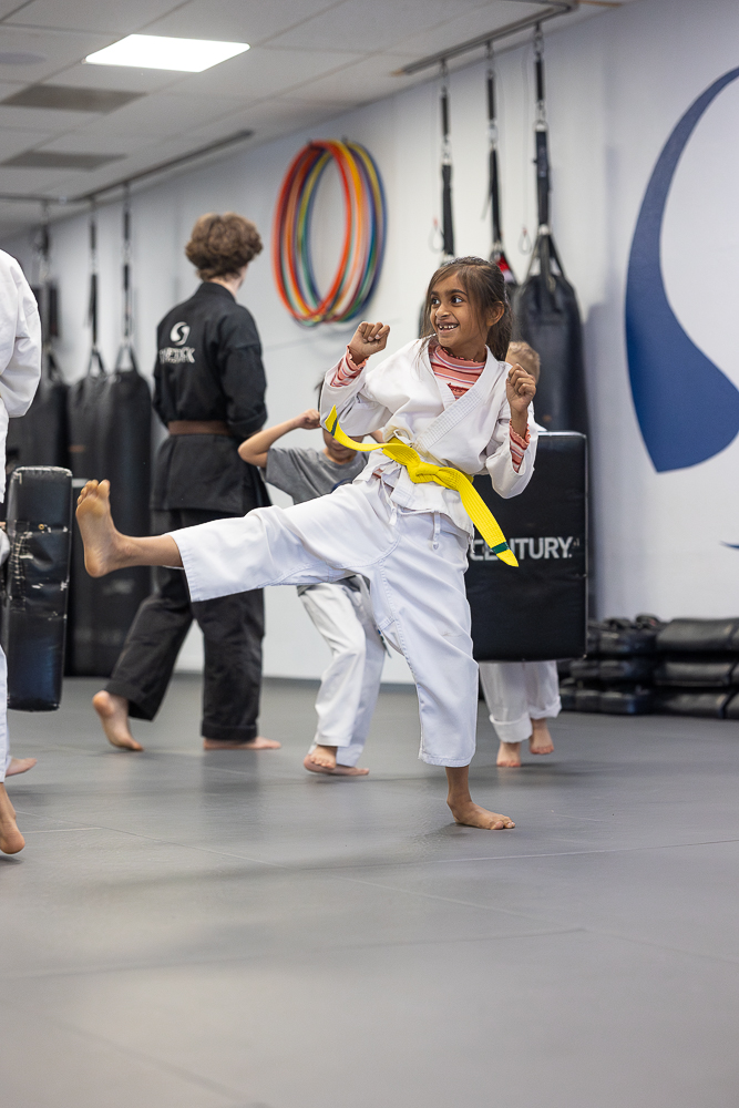 Little girl having a blast practicing her front kick.