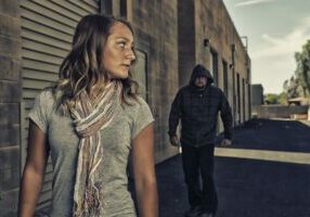 Woman in alley with man following stalking self defense